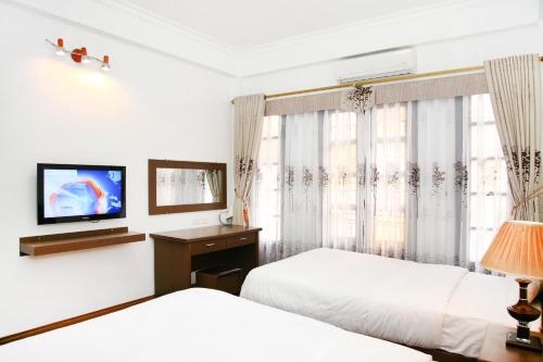 Postel nebo postele na pokoji v ubytování Bluebell Hotel