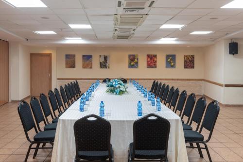 a conference room with a long table with chairs at Kinar Galilee in Kinar
