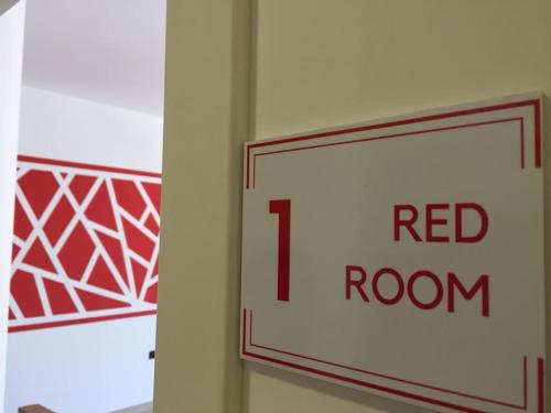 a red room sign on a wall at B&B CORSO ROMA Room Suite & Spa in Apricena