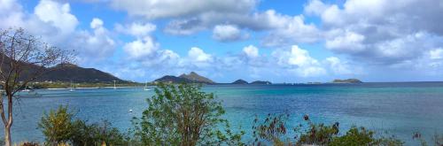 a view of a large body of water with mountains at Green Roof Inn in Carriacou