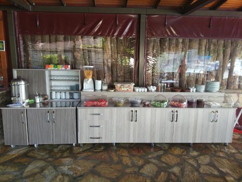 a kitchen with a counter with lots of food at Dalyan Pension in Dalyan