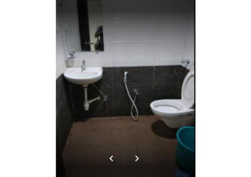 a bathroom with a sink and a toilet at Deluxe Room near Calangute Mall in Calangute