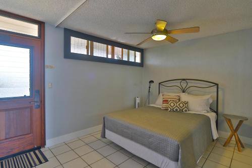 a bedroom with a bed and a ceiling fan at Hale Kai O'Kihei 314 in Kihei
