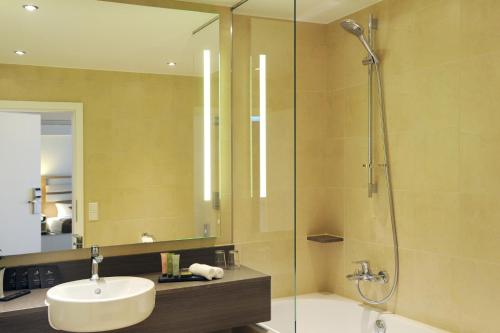 a bathroom with a sink and a shower at Hotel Goldener Knopf in Bad Säckingen