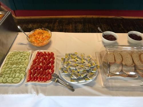 a table topped with different types of snacks and desserts at Hotel Repvåg in Repvåg