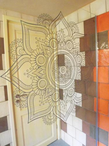 a door with a mandala painted on the wall at Casa Pablo in Badalucco