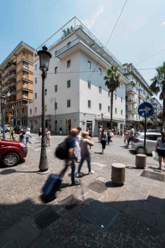 a group of people walking on a city street at Hotel Montestella in Salerno