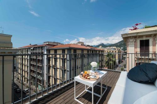a balcony with a table with food on it at Hotel Montestella in Salerno