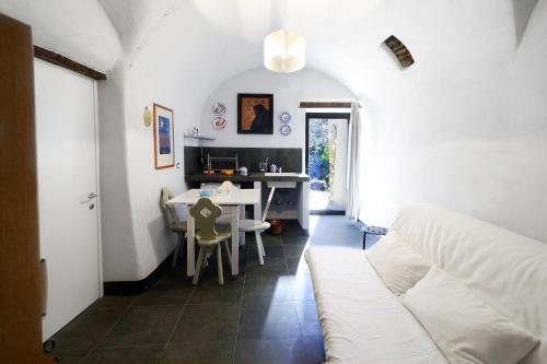 a living room with a white couch and a table at I Valloni Apartments in Imperia