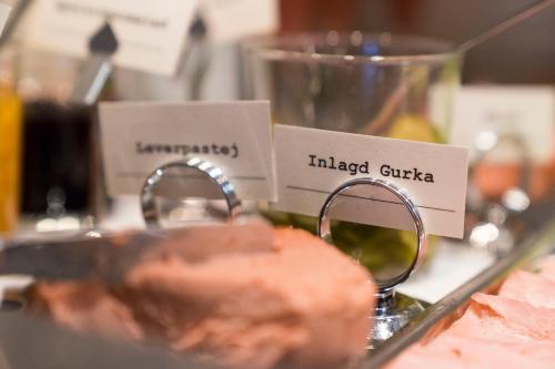 a display of food on a counter with signs at Åtellet Hotell in Norrtälje