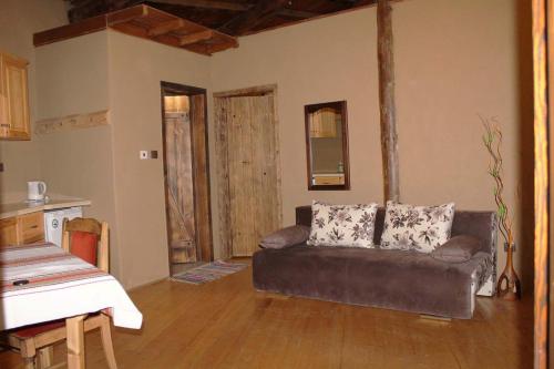 a living room with a couch and a kitchen at Eco Village Under the Cliffs in Ilindentsi