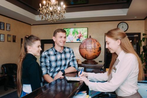 a group of people standing around a counter at Globus Hotel in Ternopilʼ