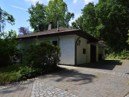 a small white building with a roof at Romantic Mansion in Strotzb sch by the Forest in Strotzbüsch