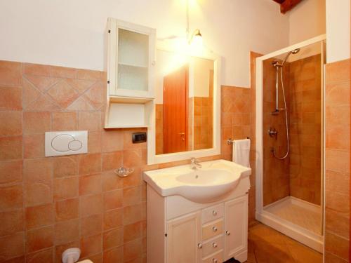 ein Bad mit einem Waschbecken und einer Dusche in der Unterkunft Cozy Holiday Home with Swimming Pool near Lake in Liguria in Bolano