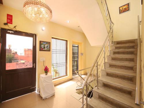 a lobby with stairs and a door with a window at Hotel Sham Villa in Amritsar