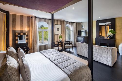 a bedroom with a large bed and a living room at Baglioni Hotel London - The Leading Hotels of the World in London
