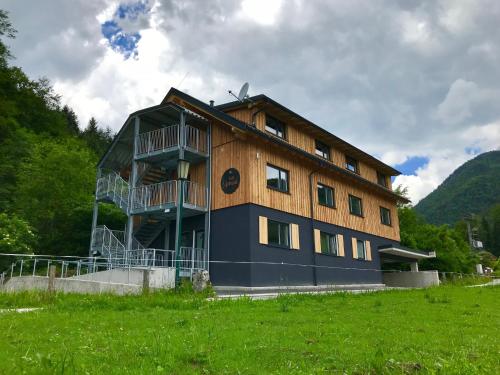 a large wooden building in a field of grass at zum Sigismund - kiss & sleep in St. Wolfgang
