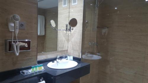 a bathroom with a sink and a shower at Senator Barajas in Madrid