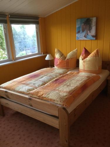 a large bed in a room with a window at Ferienhaus am Kyffhauser in Kelbra