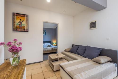 a living room with a couch and a table at Apartment Brzac in Brzac
