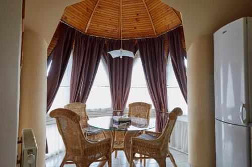 a dining room with a table and chairs and a window at Prémium Home in Pécs