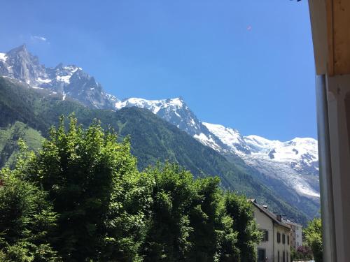 a view of a snow covered mountain from a window at Appart'Hotel Aiguille Verte & Spa in Chamonix-Mont-Blanc
