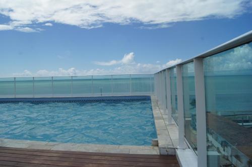 a swimming pool on the side of a building at Anjos Praia Hotel in João Pessoa