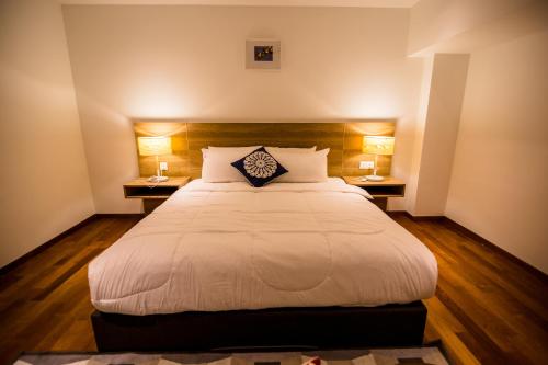 a bedroom with a large bed with two night stands at Sunrise Gurney in George Town