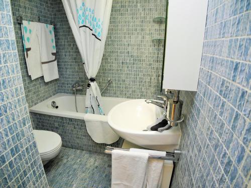 a small bathroom with a sink and a toilet at Apartment Irene - Casa Centro in Ascona