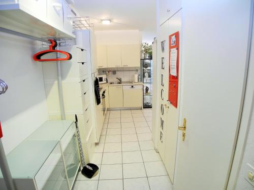a hallway in a kitchen with a white tile floor at Apartment Irene - Casa Centro in Ascona