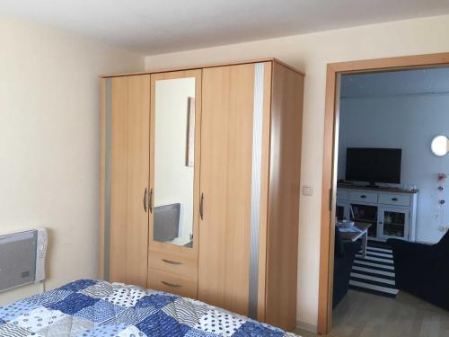 a bedroom with a closet and a bed and a television at Ferienbungalow Klein Schweden in Ostseebad Koserow