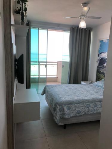 1 dormitorio con cama y vistas al océano en Praia Grande Arraial Do Cabo, en Arraial do Cabo