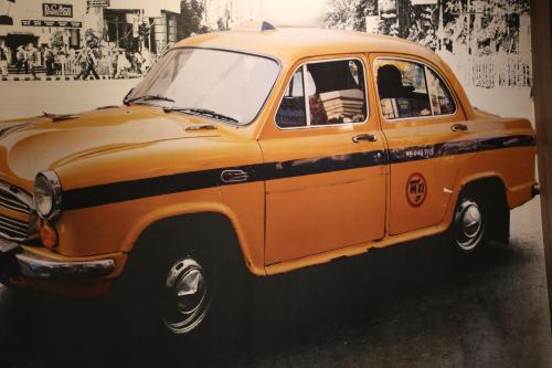 an old orange car is parked in a room at Istanaku in Manado
