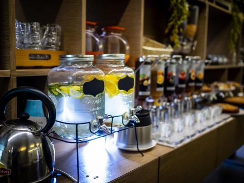 a counter with two jars of drinks on a table at Hotel Villa Lalla in Rimini