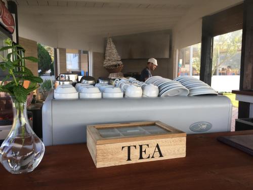 a table with a tea set on top at Kopsis Beach Hotel in Pefkochori