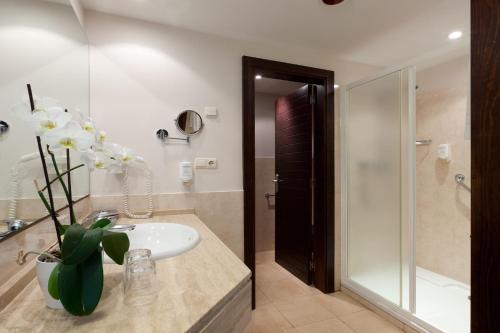a bathroom with a white sink and a shower at Impressive Playa Granada Golf in Motril