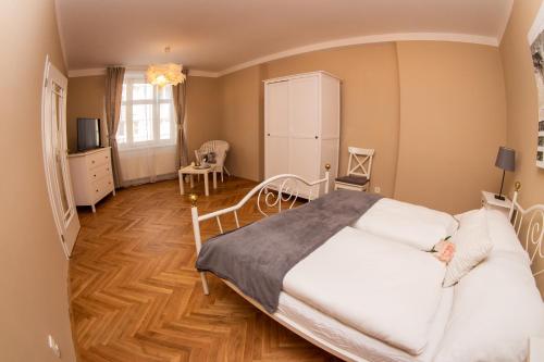 1 dormitorio con 1 cama, mesa y sillas en Apartmán U krále Tylova 515, en Jičín