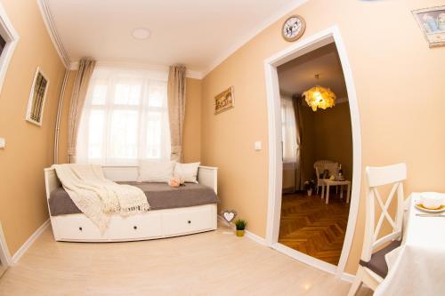 a small bedroom with a bed and a window at Apartmán U krále Tylova 515 in Jičín