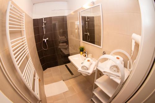 a small bathroom with a sink and a shower at Apartmán U krále Tylova 515 in Jičín