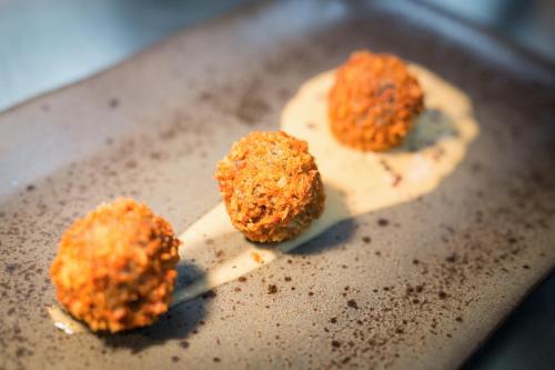 three meatballs on a spatula on a pan at Radisson RED Hotel, Glasgow in Glasgow