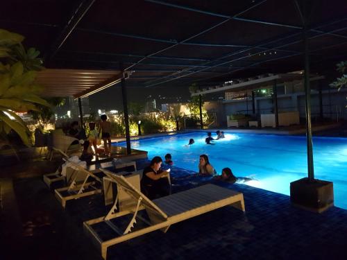 a group of people in a swimming pool at night at KC Studio 5 at Horizon 101 Cebu in Cebu City