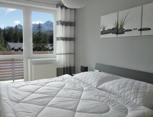 Postel nebo postele na pokoji v ubytování Apartmán s výhľadom na Tatry
