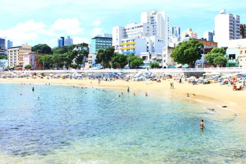 a group of people in the water at a beach at Hit Hotel in Salvador