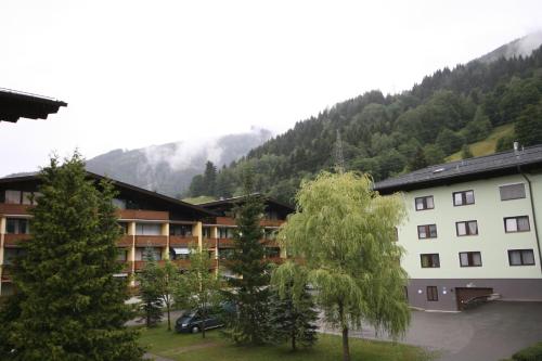 a group of buildings in front of a mountain at Appartements Domizil in Kaprun