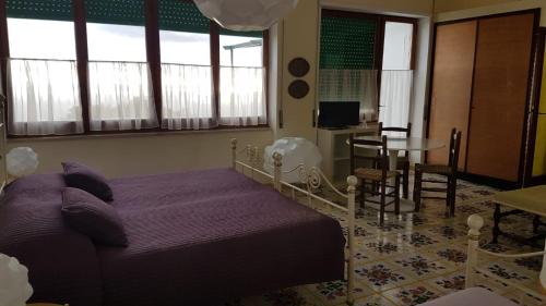 a bedroom with a bed and a table and chairs at Il Rifugio B&B Capri in Anacapri