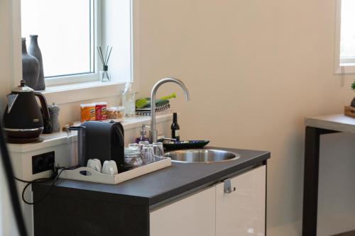 a kitchen counter top with a sink and a sink at Watertorenhotel Nes in Nes