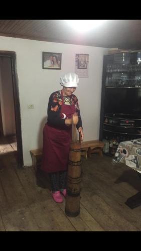 a woman is standing in a living room at Kulla e Sadri Lukes in Theth