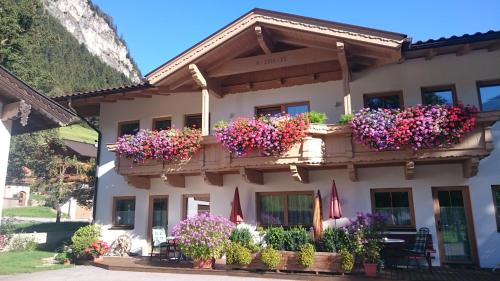 a building with flower boxes on it at Ferienhaus Gredler in Mayrhofen