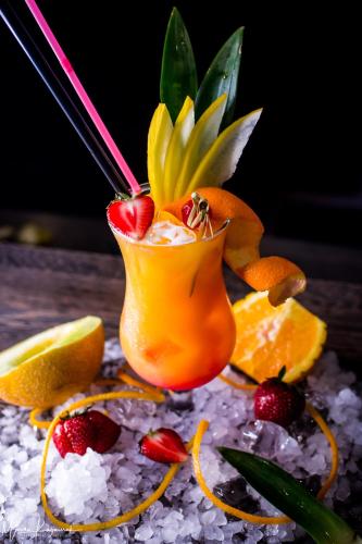 a drink in a glass with fruit on a table at Hotel Na Skarpie in Szklarska Poręba