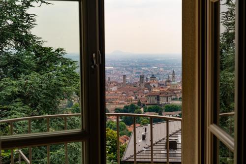 a view of a city from a window at Relais San Vigilio al Castello in Bergamo
